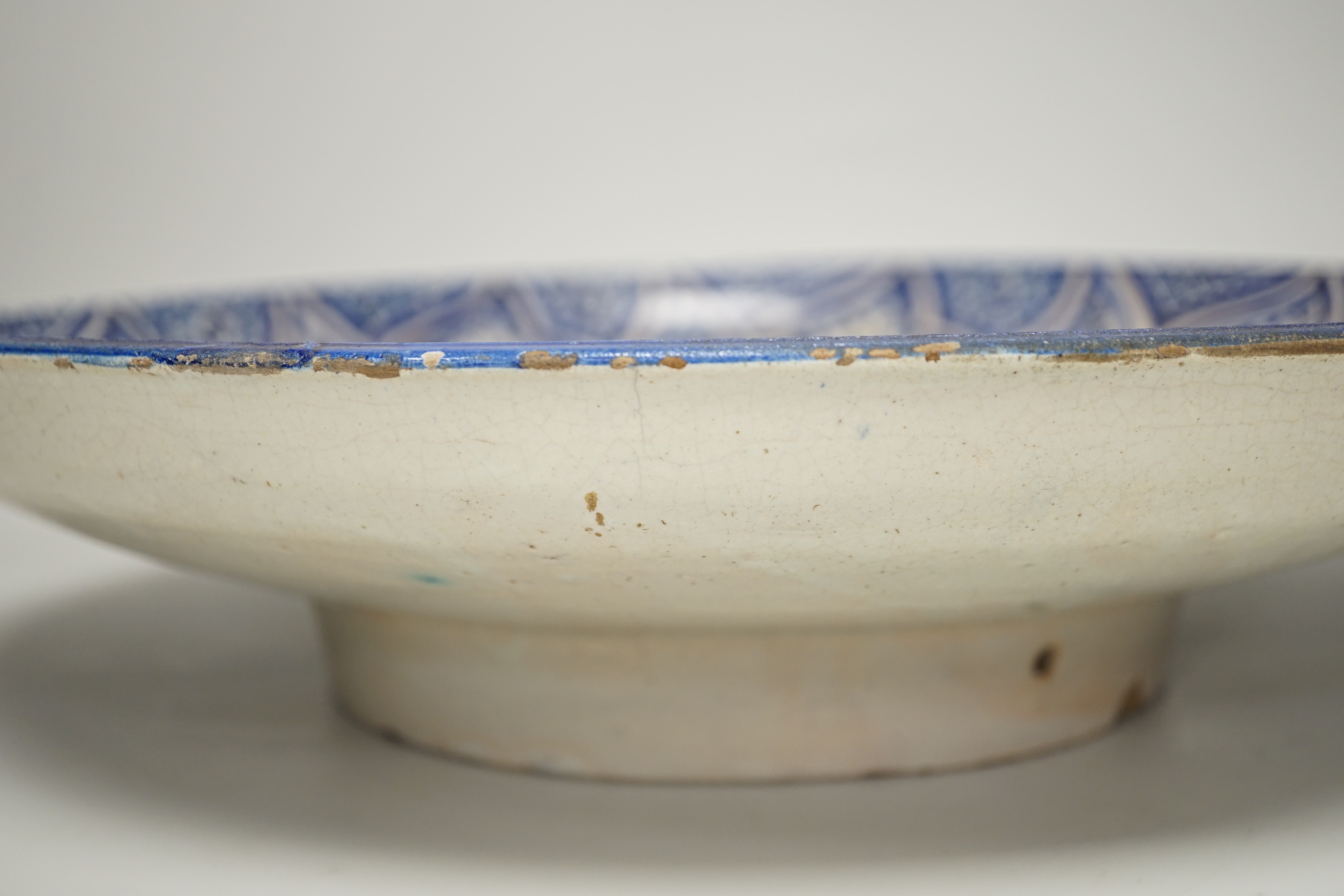 A large Moroccan pottery blue and white wall plate, 40cm diameter